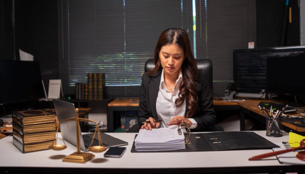 Female lawyer is working on legal documents in an office.