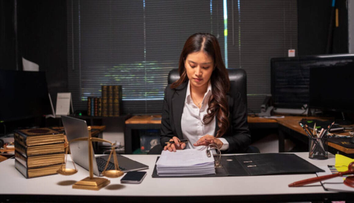 Female lawyer is working on legal documents in an office.